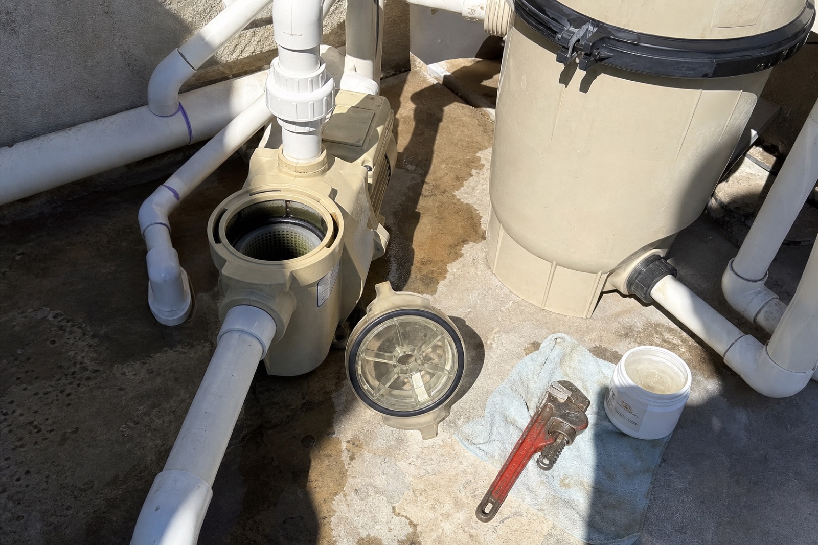 Pool pump strainer and cartridge filter mid-service on a Fort Worth equipment pad