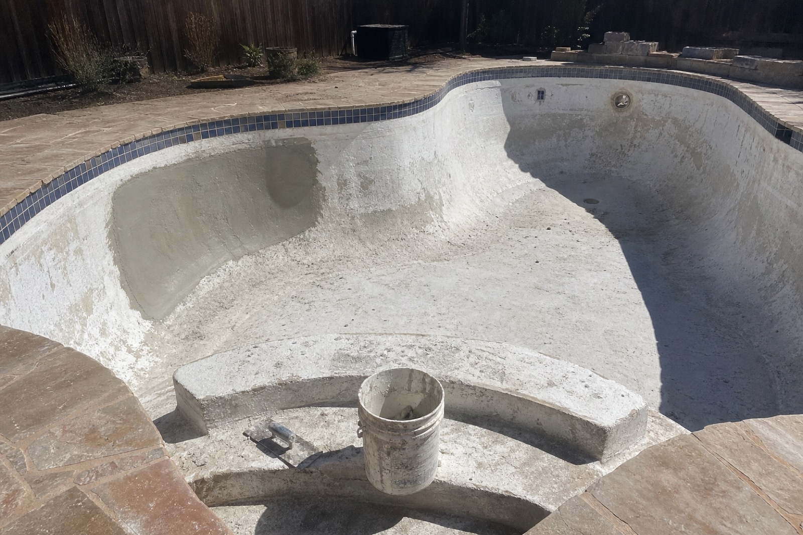 Drained residential pool shell mid-replaster during a Sea Blue renovation in DFW